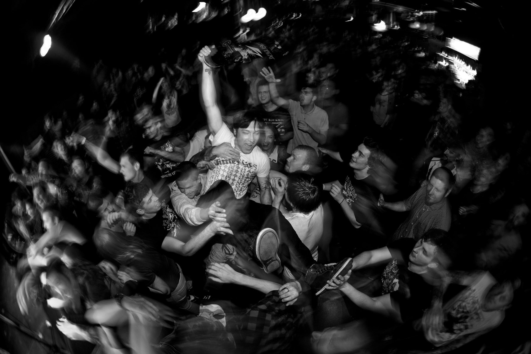 A packed crowd crowd-surfing at a live show